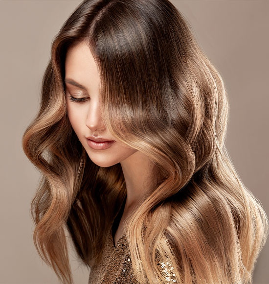 A brunette client shows her I-Tip hair extensions near The Woodlands.