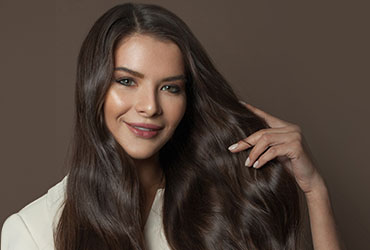 A woman shows her I-Tip hair extensions in The Woodlands.
