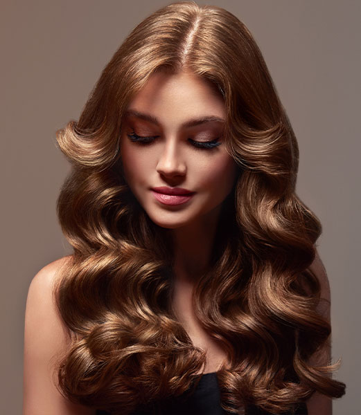 Gorgeous brunette waves achieved with Russian and European hair extensions near The Woodlands.