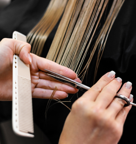 A woman gets her hair cut at Hair Extensions of Houston